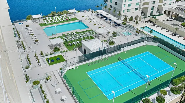 a view of a lake with a bench and a big yard