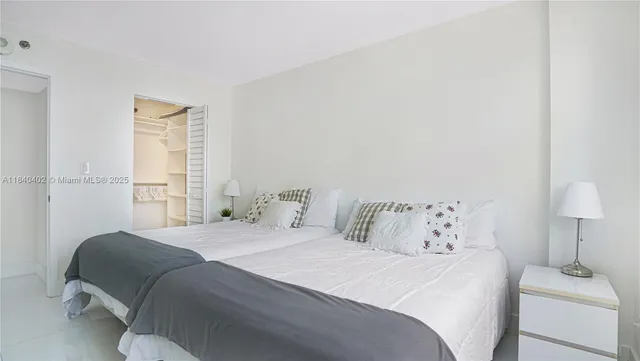 a bedroom with a bed and a lamp