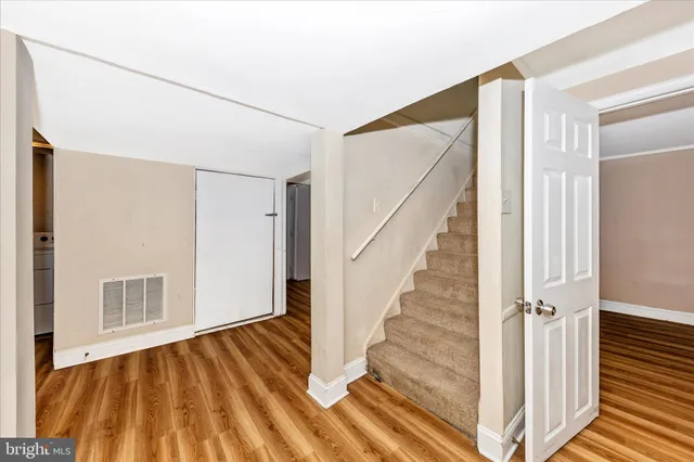 a view of front door with wooden floor and stairs