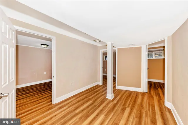 a view of a room with wooden floor and a bathroom