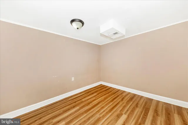 a view of a room with wooden floor