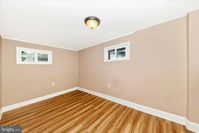 a view of a room with wooden floor and white walls