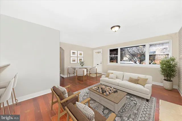 a living room with furniture and a window with garden view