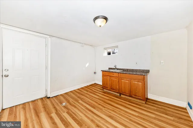 a view of a room with wooden floor