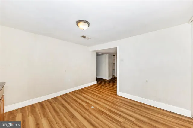 a view of a room with wooden floor