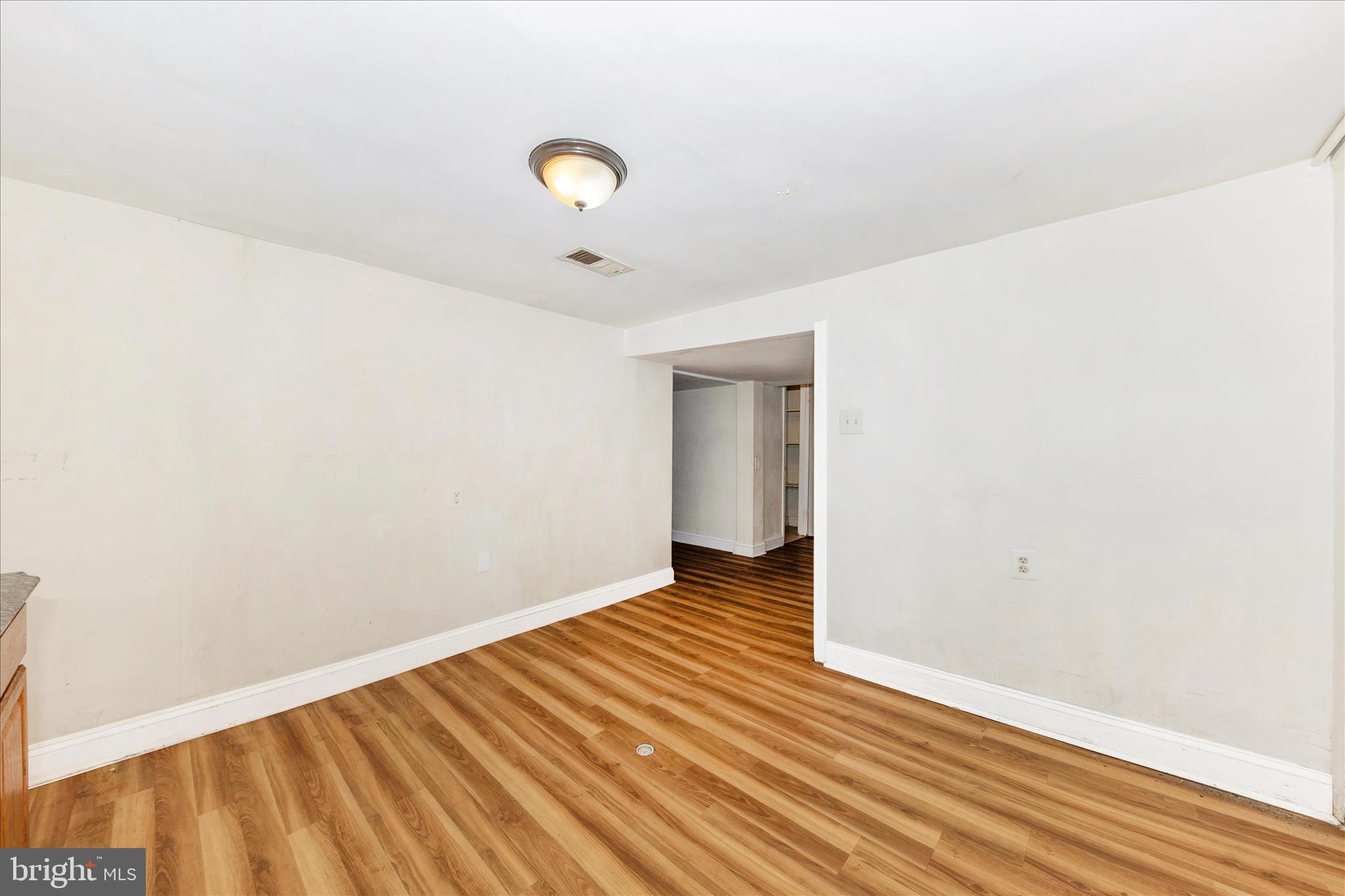 8109 Riggs Road Hyattsville, MD 20783 - Photo 35 of 54 a view of a room with wooden floor