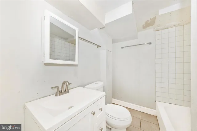 a white toilet sitting next to a bathroom sink
