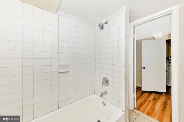 a bathroom with a bathtub and shower