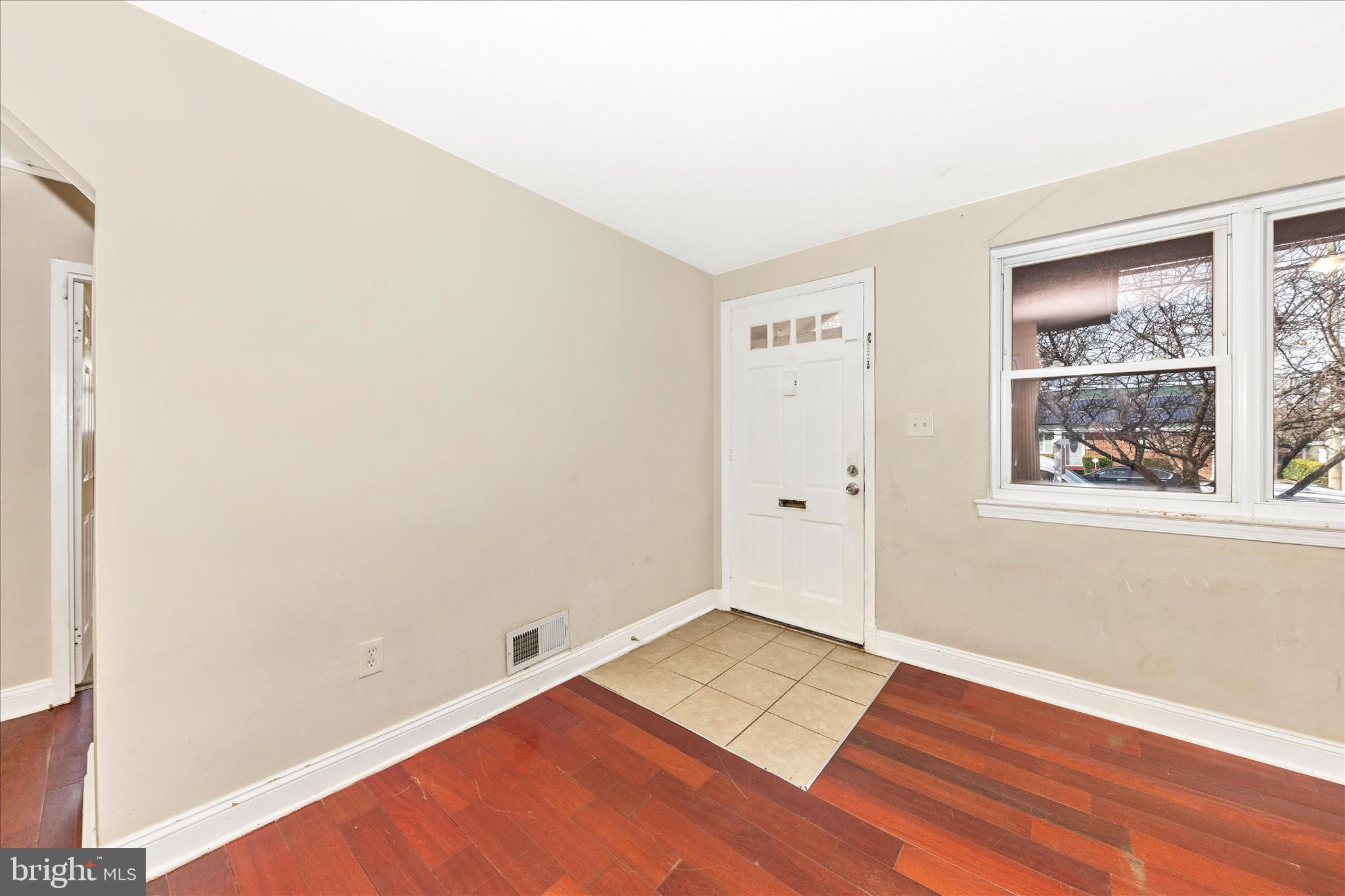 8109 Riggs Road Hyattsville, MD 20783 - Photo 5 of 54 an empty room with wooden floor and windows