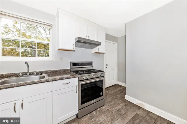 a kitchen with a stove oven and sink