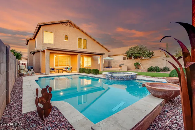 a front view of a house with swimming pool having outdoor seating