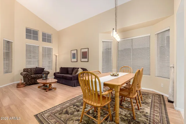 a living room with furniture a chandelier and a window