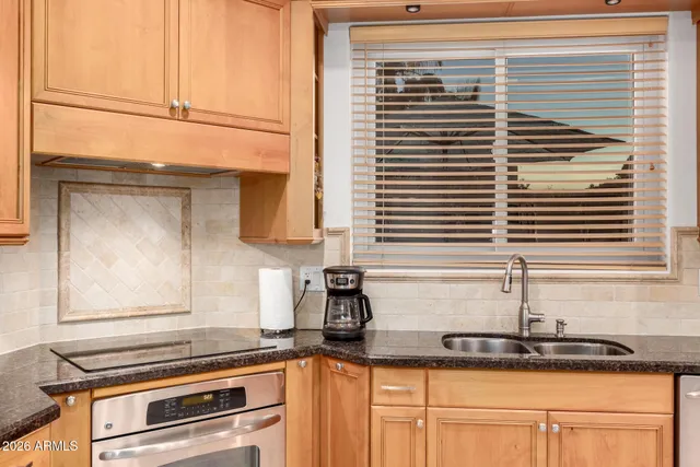 a kitchen with a sink and cabinets