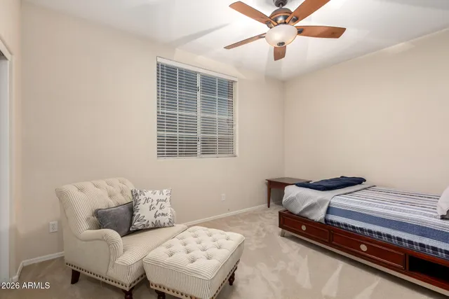 a bedroom with bed and a window