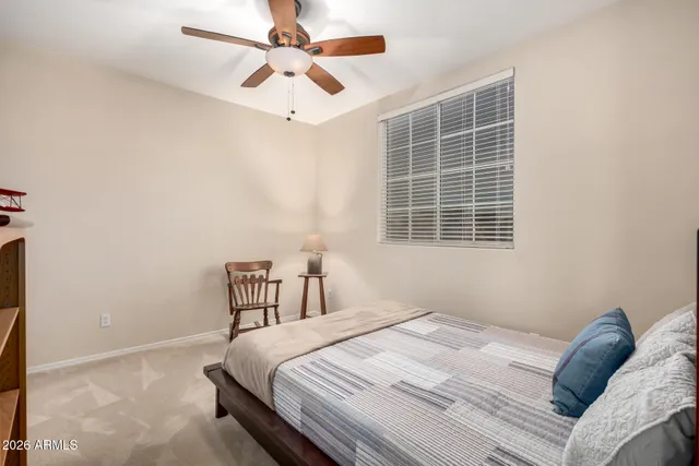 a bedroom with a bed dresser and a window