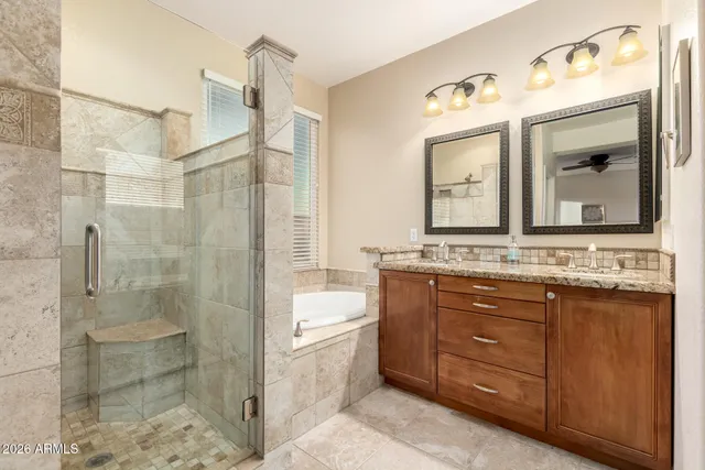 a bathroom with a granite countertop sink mirror and shower