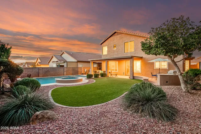 a view of a house with a backyard