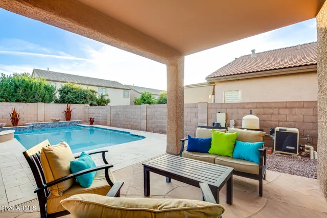 a view of an outdoor sitting area with furniture and umbrella