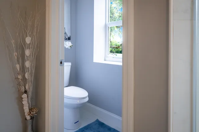 a bedroom with a bed and painting on the wall