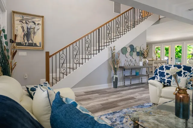 a living room with furniture flowerpot and window