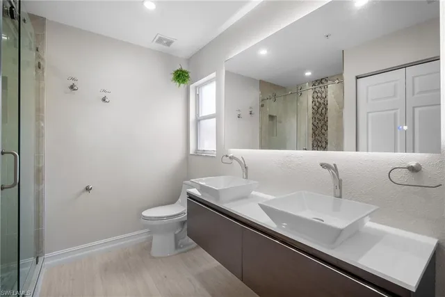 a bathroom with a shower and toilet