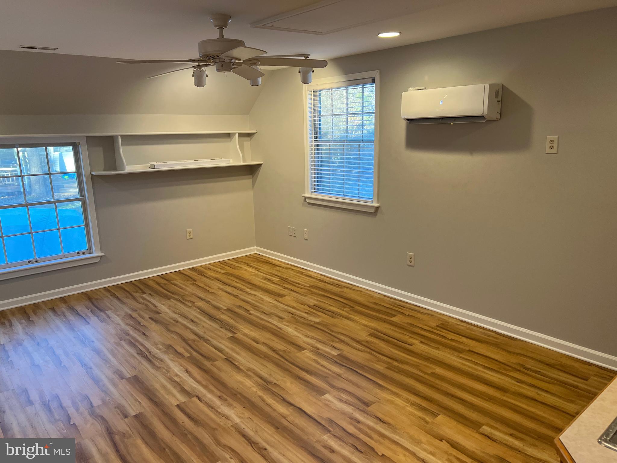 593 A Street Pasadena, MD 21122 - Photo 4 of 8 a view of empty room with wooden floor and fan
