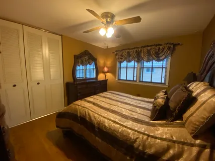a bed sitting in a bedroom next to a window