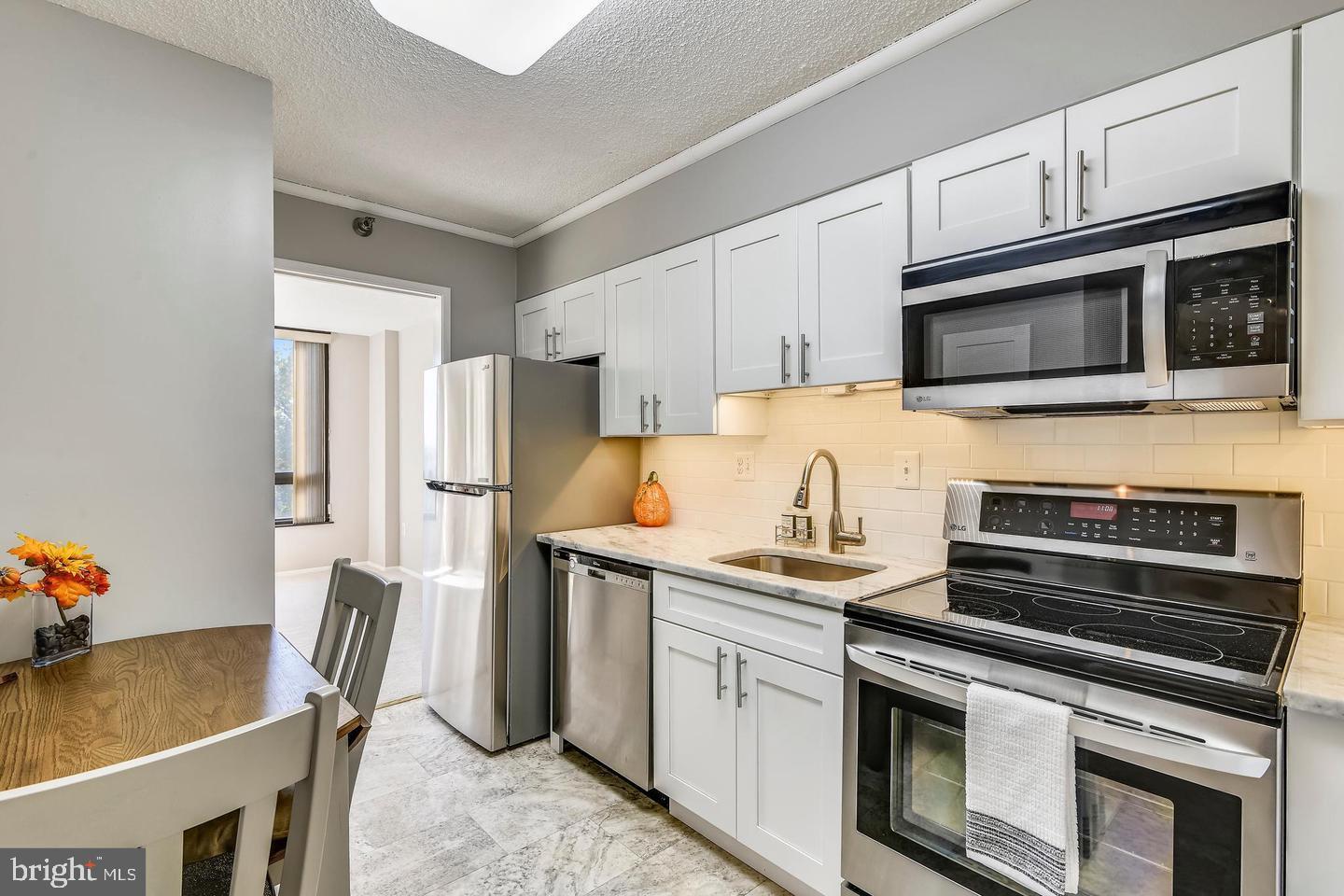 1808 Old Meadow Road, Unit 910 McLean, VA 22102 - Photo 1 of 28 Kitchen with a tile flooring.