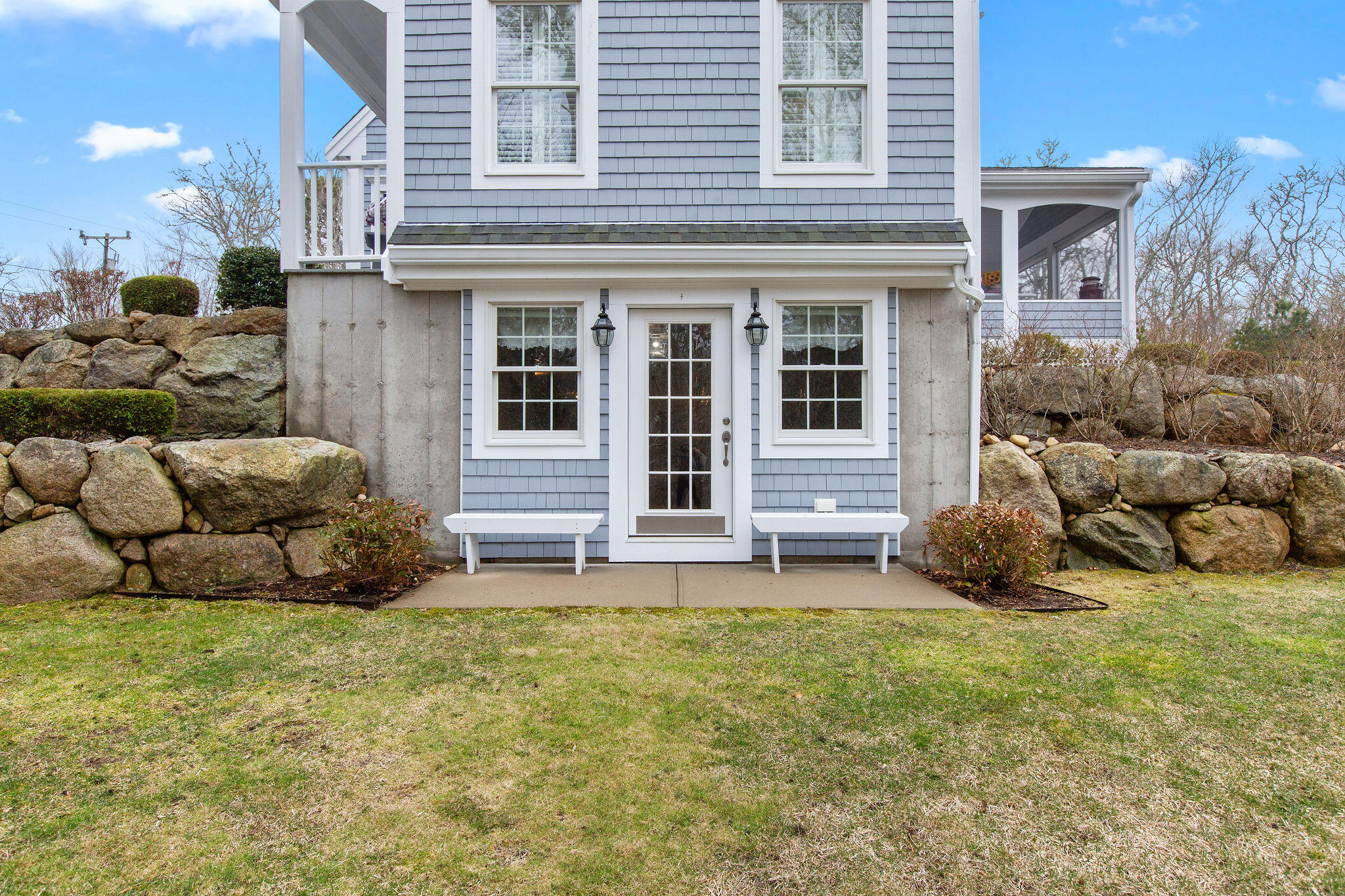 154 Beechtree Drive Brewster, MA 02631 - Photo 27 of 76 a view of a house with a large window and a yard