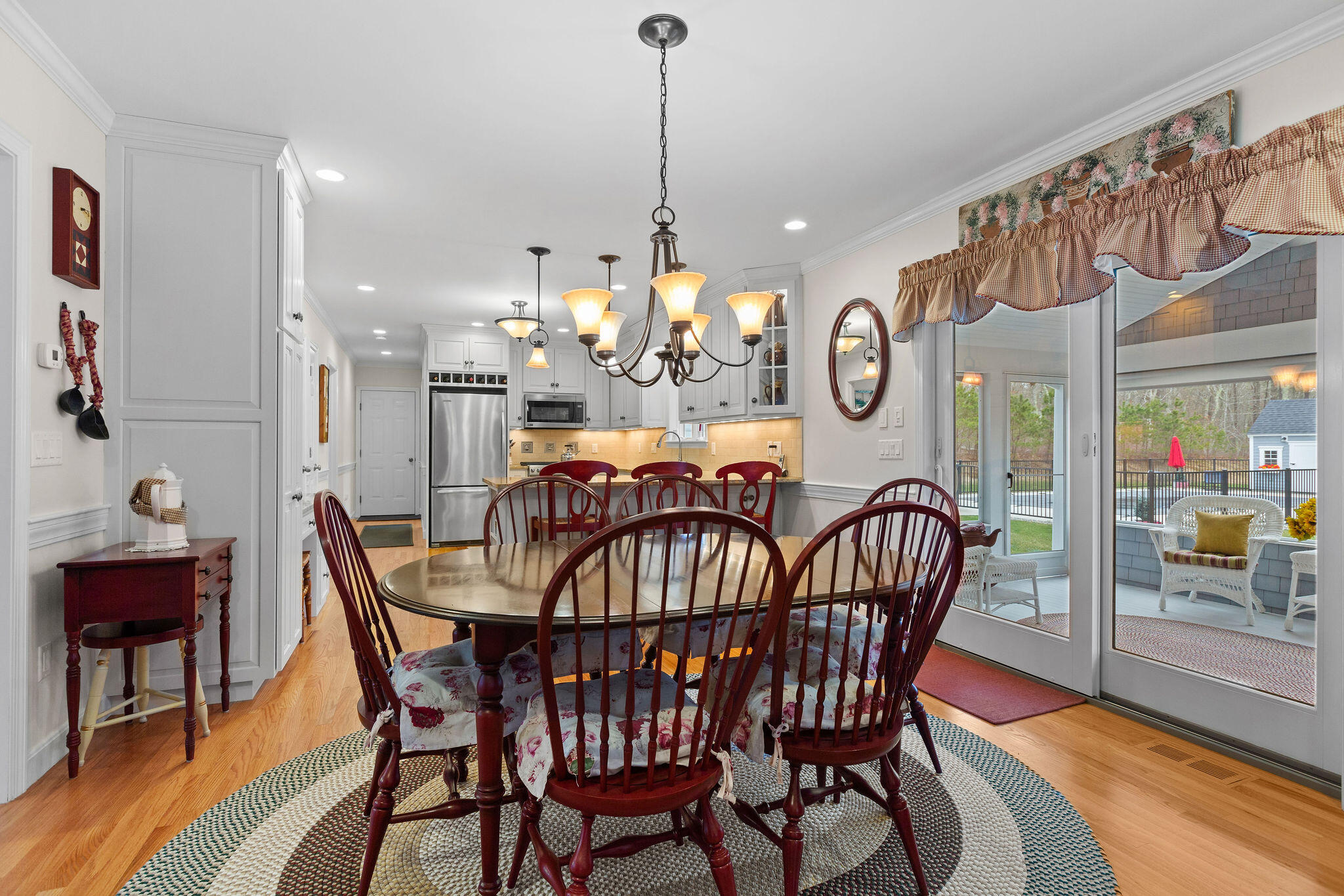 154 Beechtree Drive Brewster, MA 02631 - Photo 34 of 76 a view of a dining room and livingroom with furniture wooden floor a chandelier
