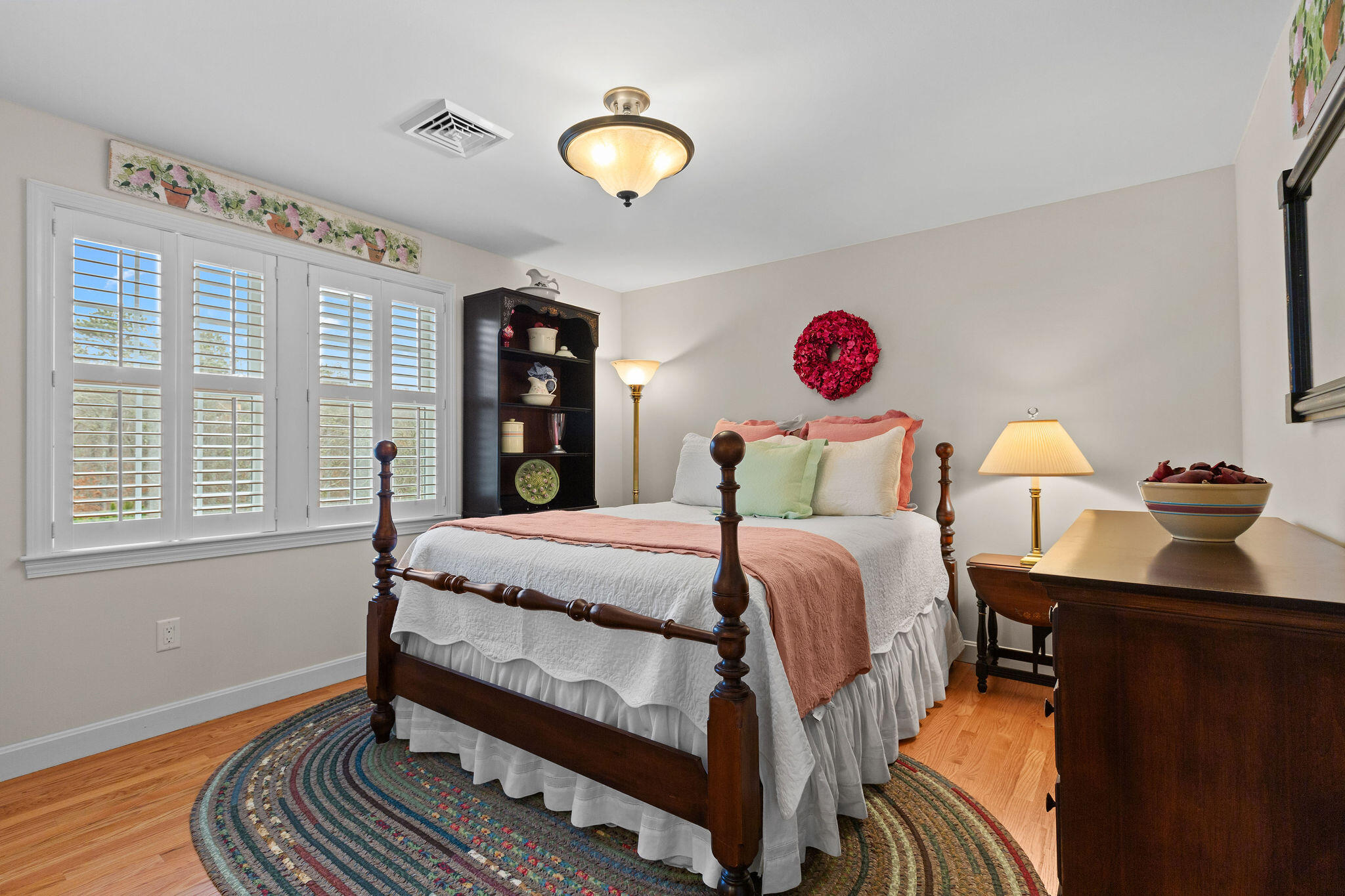 154 Beechtree Drive Brewster, MA 02631 - Photo 53 of 76 a bedroom with a bed and wooden floor