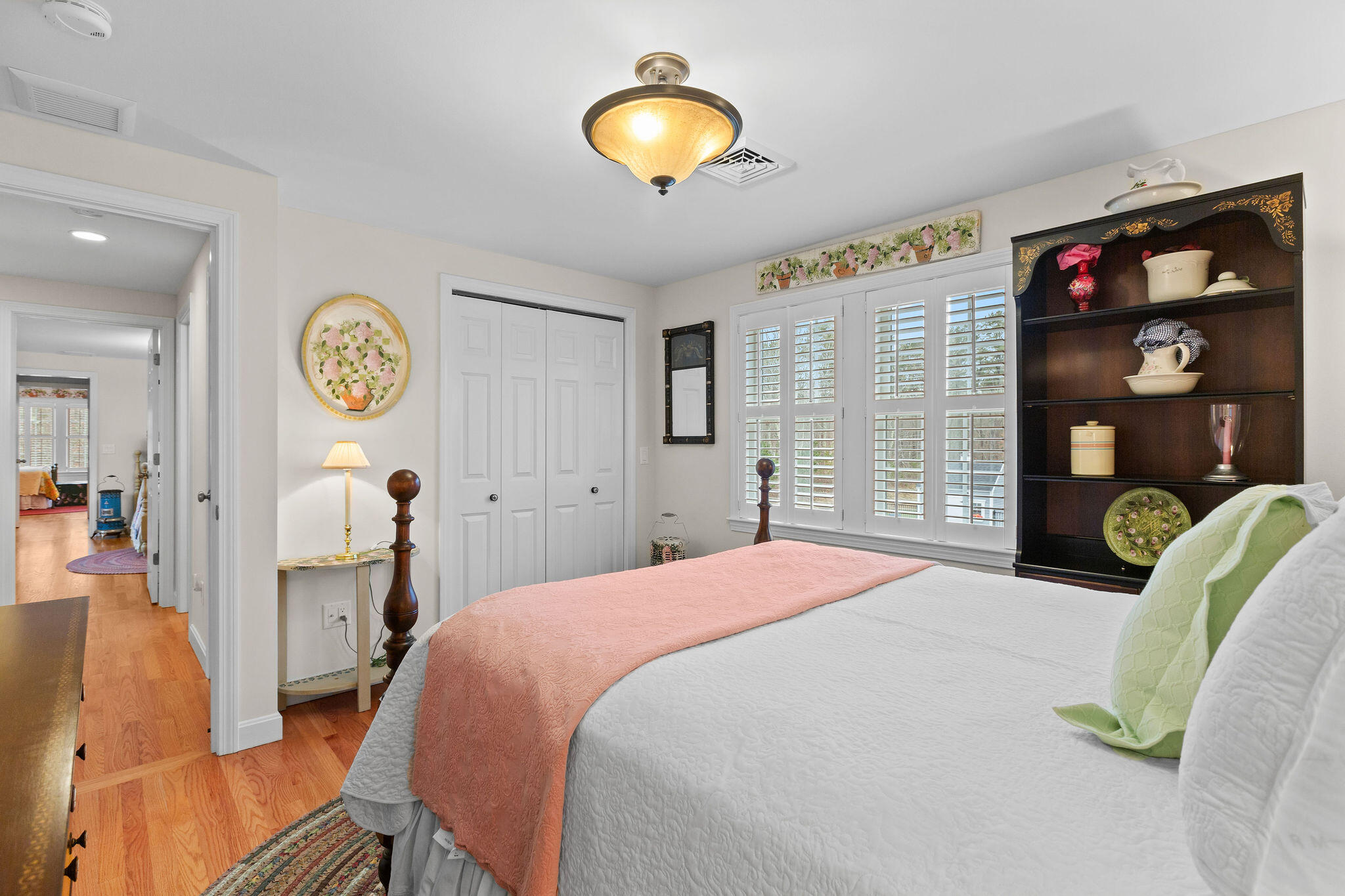 154 Beechtree Drive Brewster, MA 02631 - Photo 54 of 76 a bedroom with a bed and a chandelier