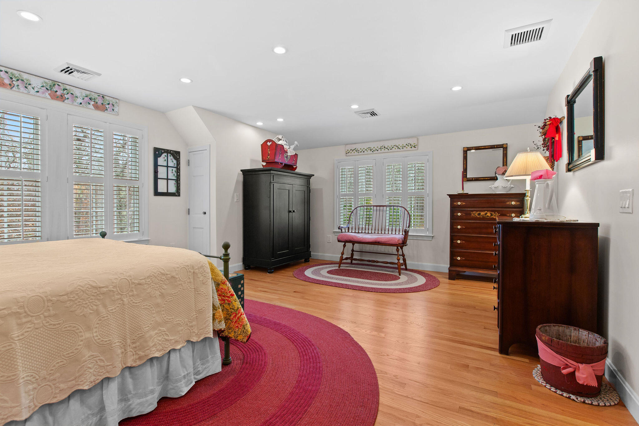 154 Beechtree Drive Brewster, MA 02631 - Photo 62 of 76 a bedroom with a bed and wooden floor