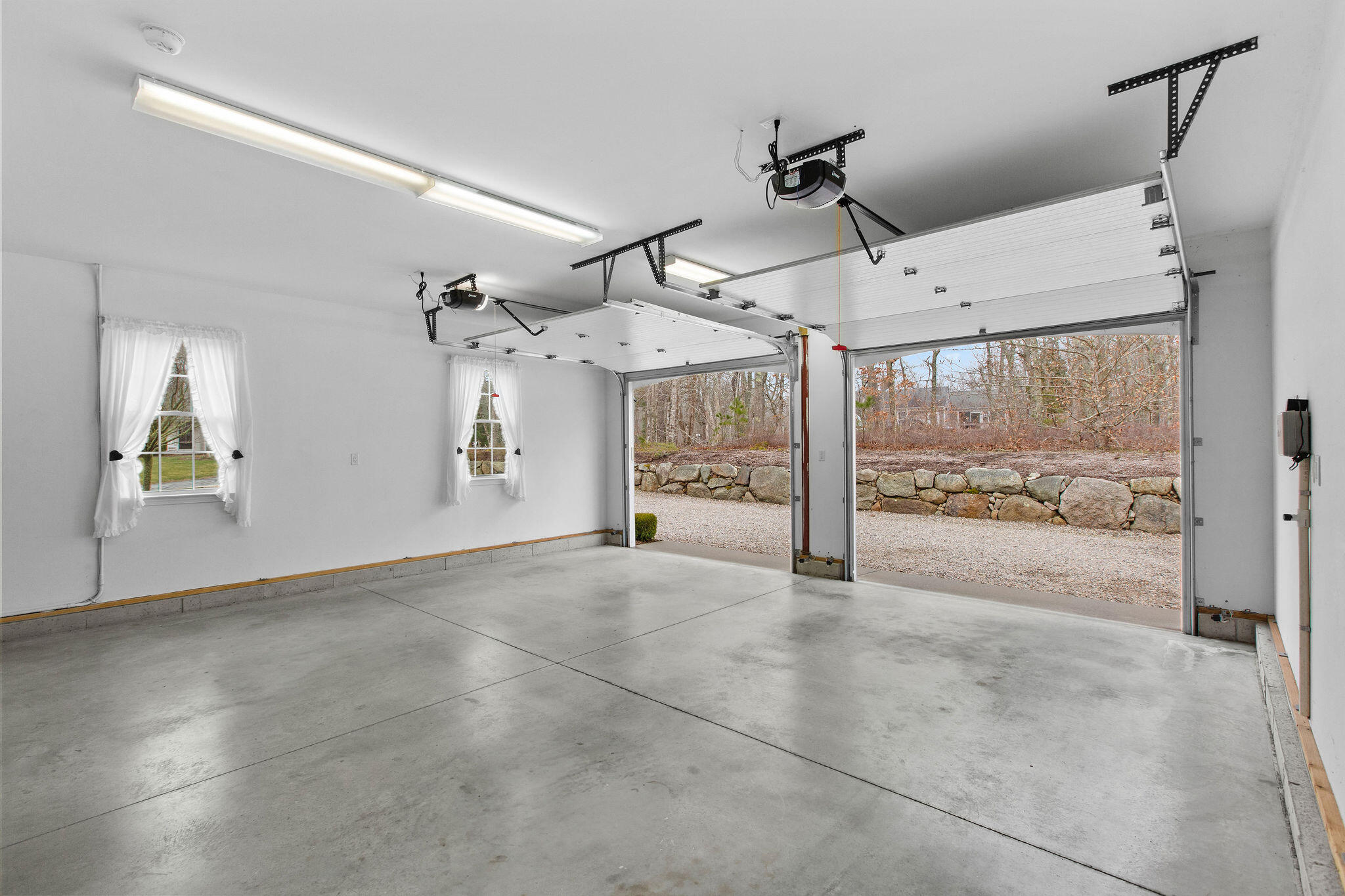 154 Beechtree Drive Brewster, MA 02631 - Photo 69 of 76 a view of a livingroom with wooden floor and a ceiling fan