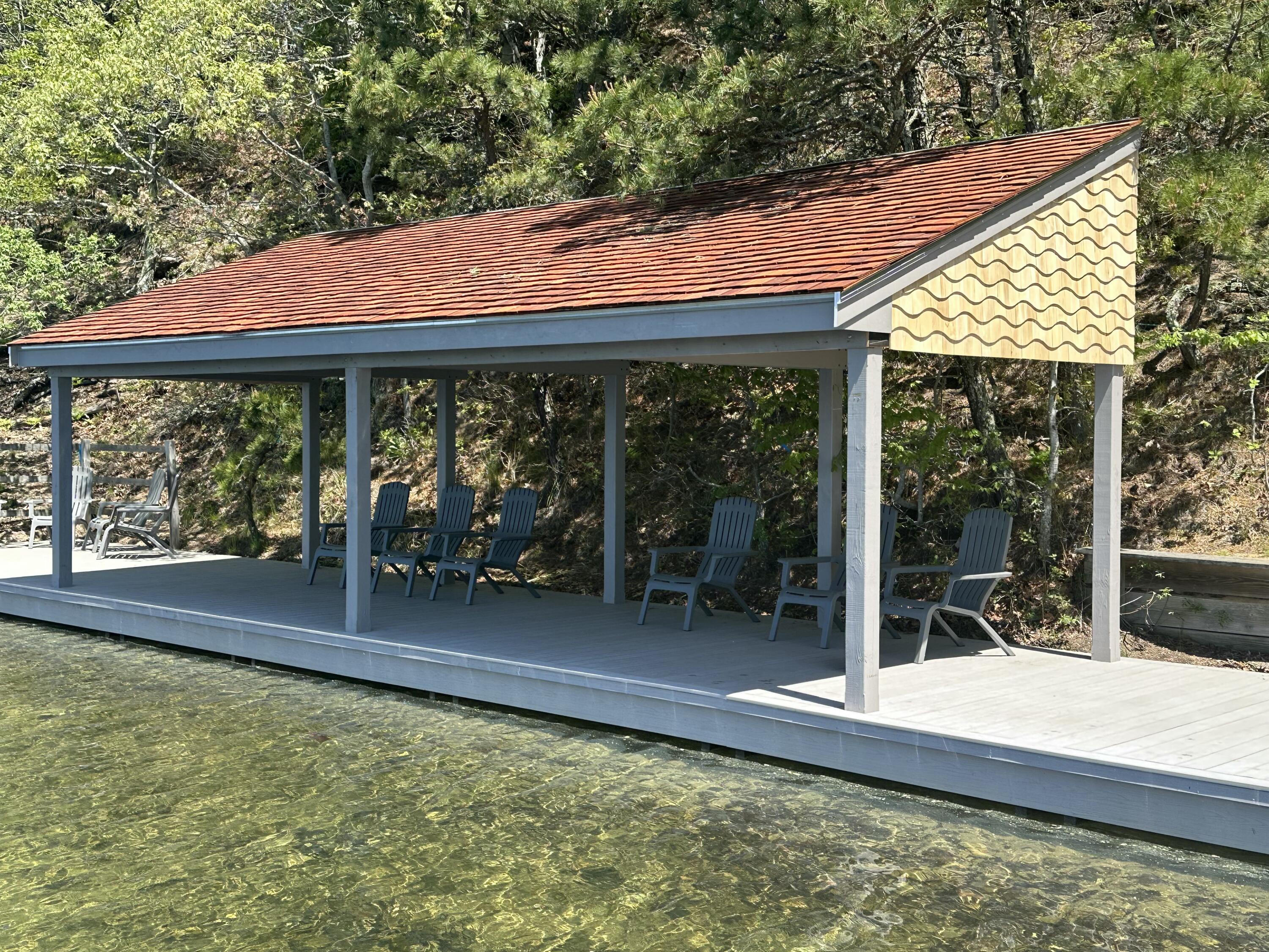 154 Beechtree Drive Brewster, MA 02631 - Photo 71 of 76 a backyard of a house with wooden floor and outdoor seating