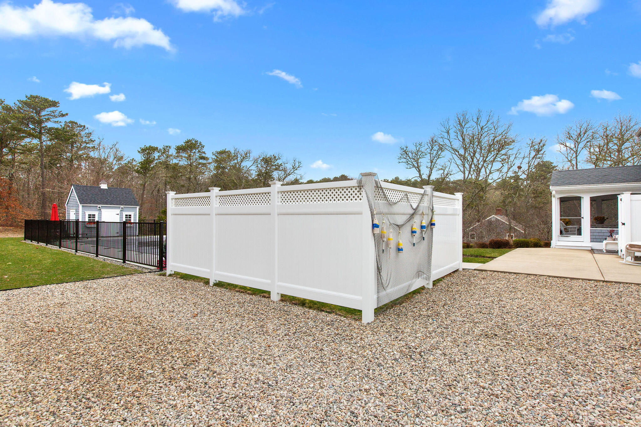 154 Beechtree Drive Brewster, MA 02631 - Photo 8 of 76 a view of a white house with a yard and table and chairs