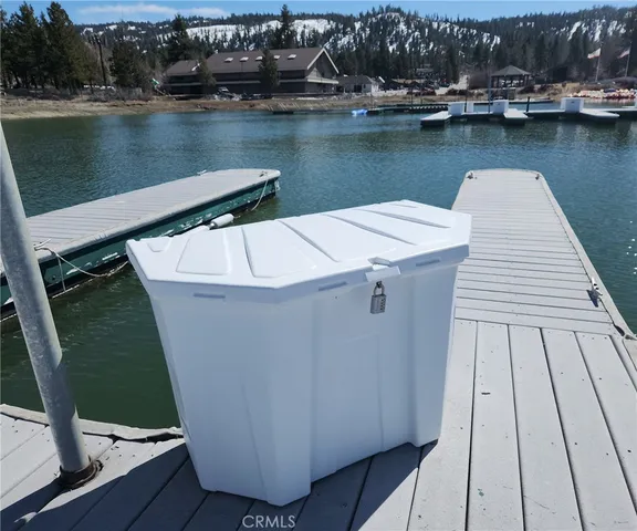 an aerial view of a house with wooden floor and lake view