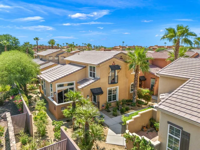 an aerial view of multiple houses with a yard