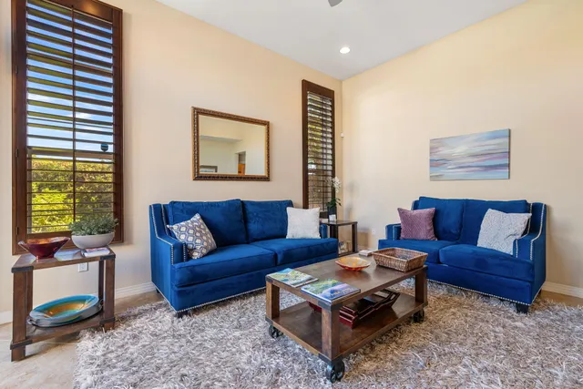 a living room with furniture a rug and a window