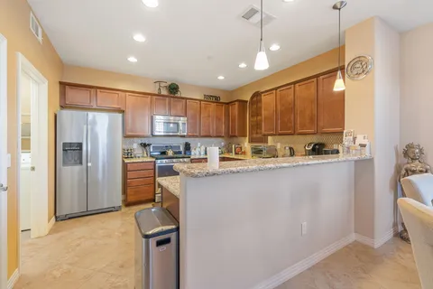a kitchen with a refrigerator a sink and cabinets