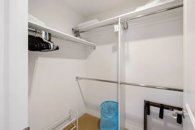 a view of a room with wooden floor and a window