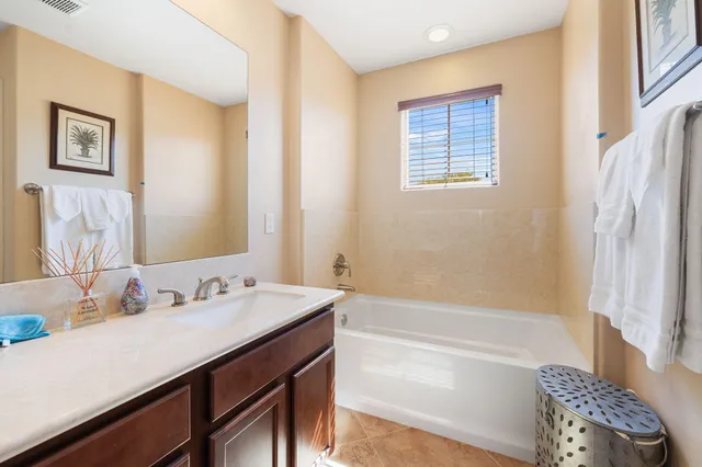 a bathroom with a tub sink and a mirror