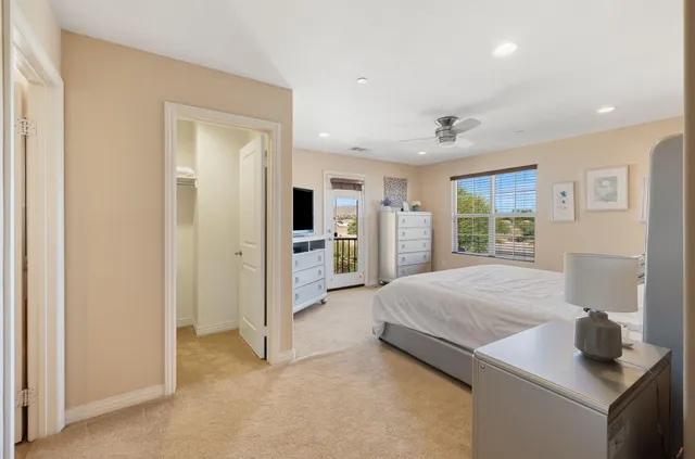 a living room with stainless steel appliances kitchen island granite countertop a refrigerator and a sink