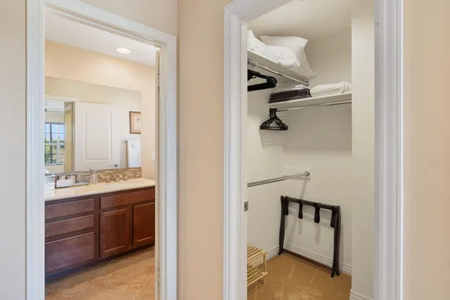 a bathroom with a granite countertop sink mirror and double