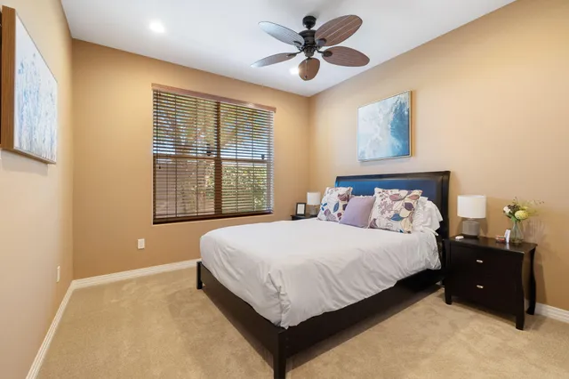 a bed sitting in a bedroom next to a window