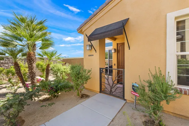 a couple of potted plants in front of door