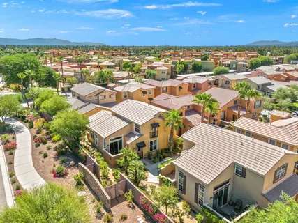 an aerial view of residential houses with a city view