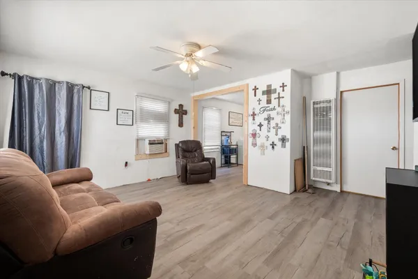 a living room with furniture and wooden floor