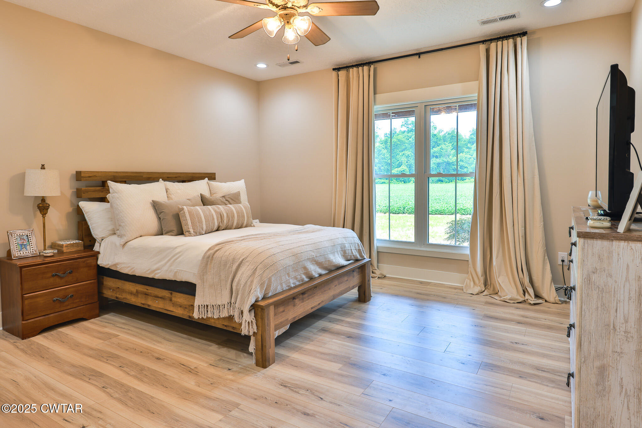 201 Trevathan Road Martin, TN 38237 - Photo 44 of 50 a large bedroom with a bed tv and table