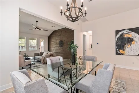a living room with furniture chandelier and a window